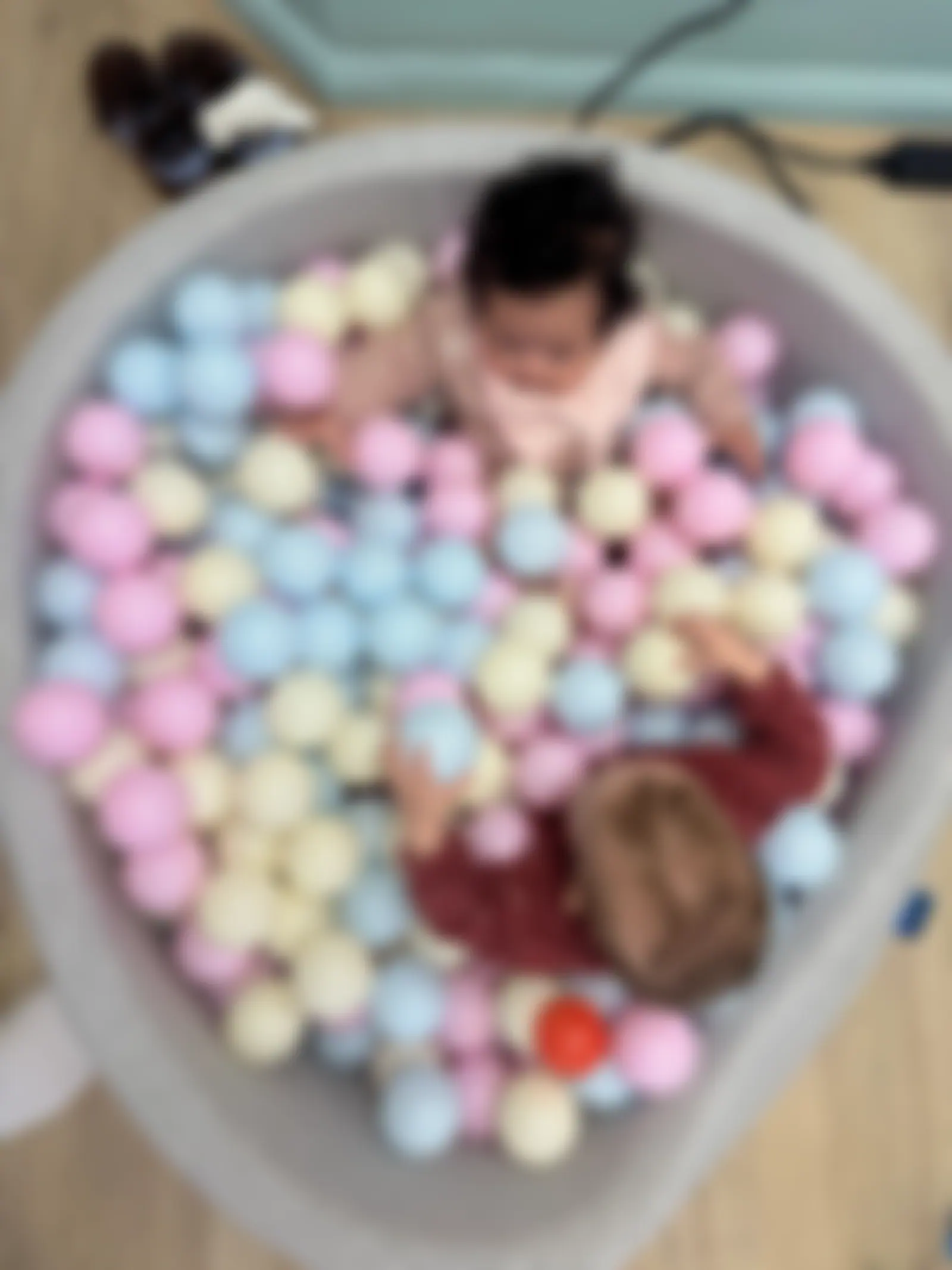 Two little ones in the pastel ball pit