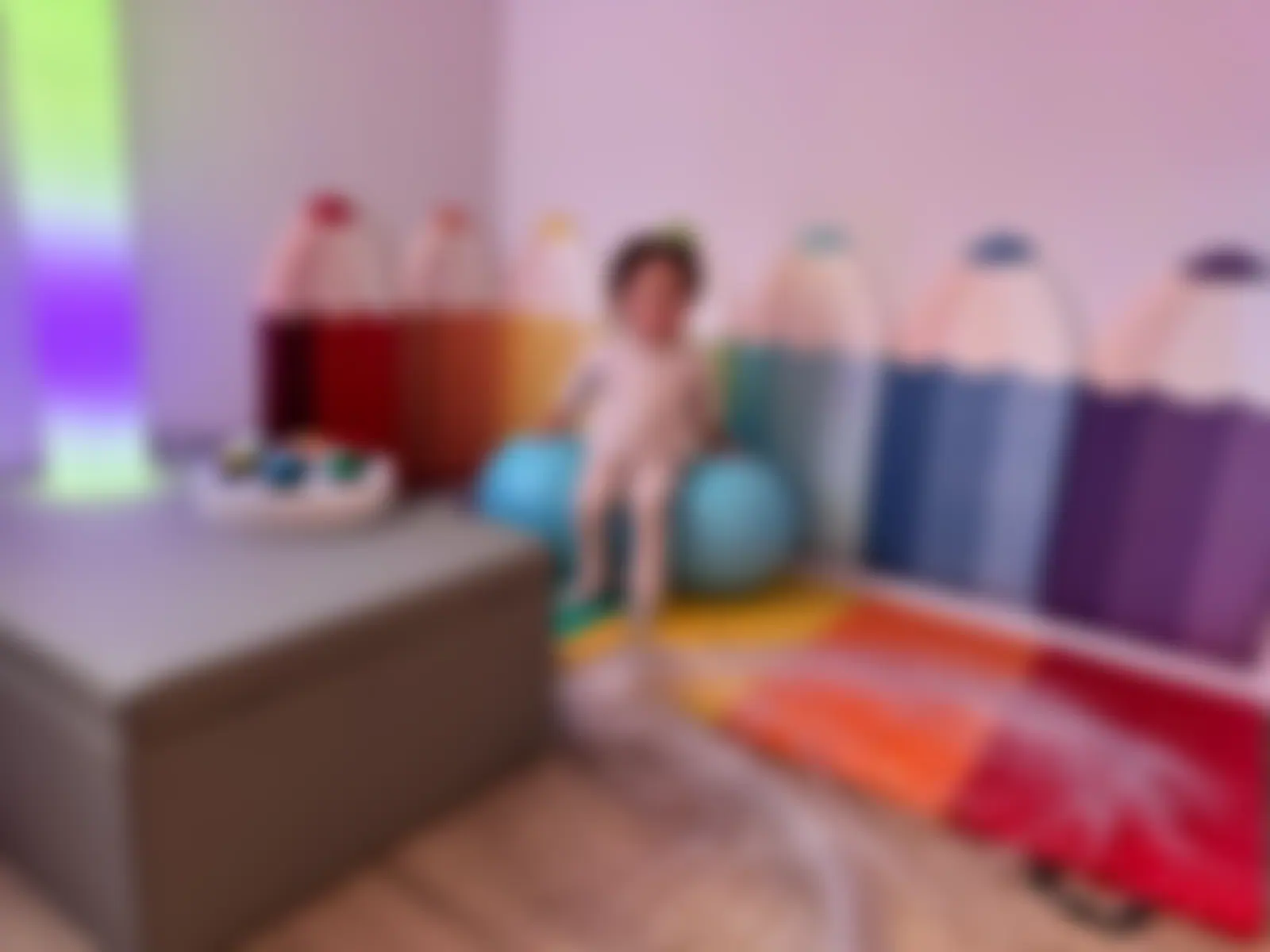 Sensory room at The Nurture Nest in Southall with a colour-changing light column and giant pencil wall