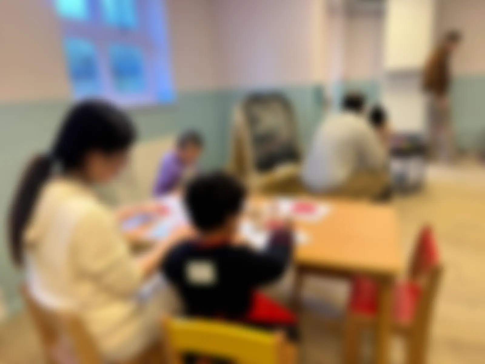 Small group table activity beside the easel